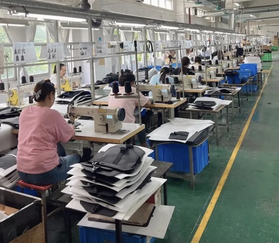 Bag production floor at our Guangzhou sourcing partner in Baiyun District. Sewing lines mid-batch